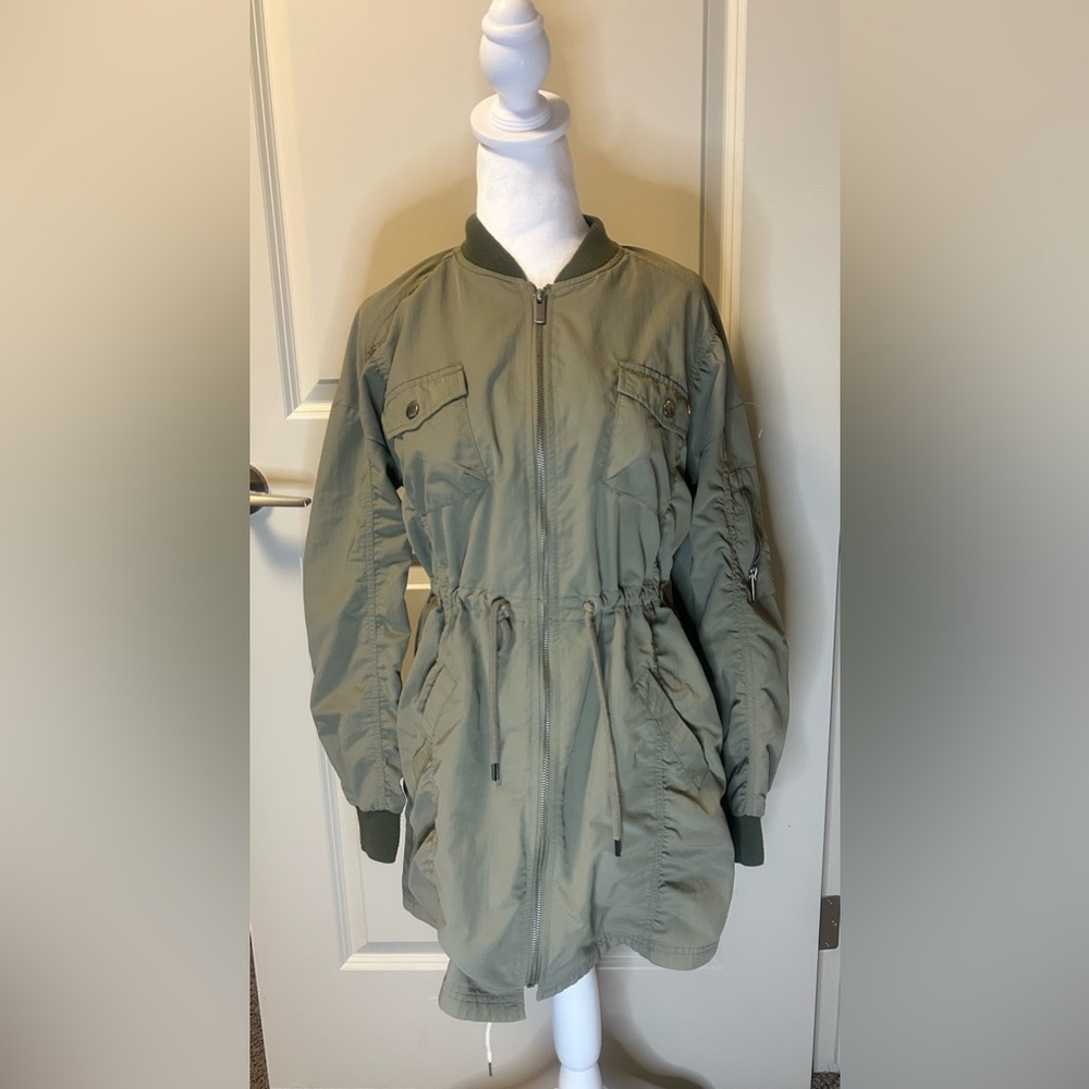 Noisy may woman’s small green trench